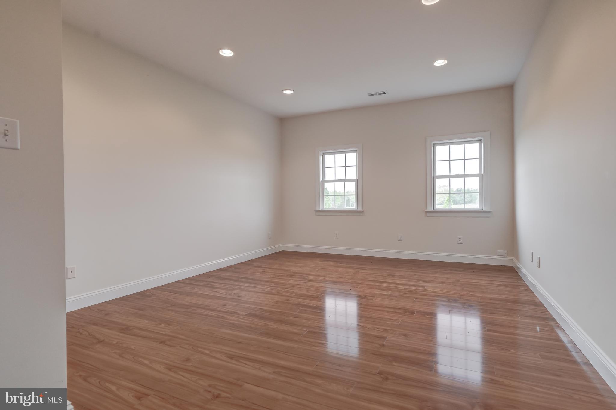2066 Byrd's Mill Road Newtown, VA 23126 - Photo 35 of 61 a view of an empty room with wooden floor and window