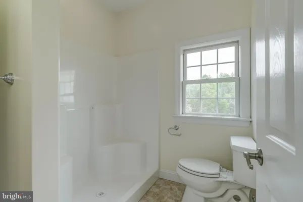 a bathroom with a granite countertop sink and washing machine