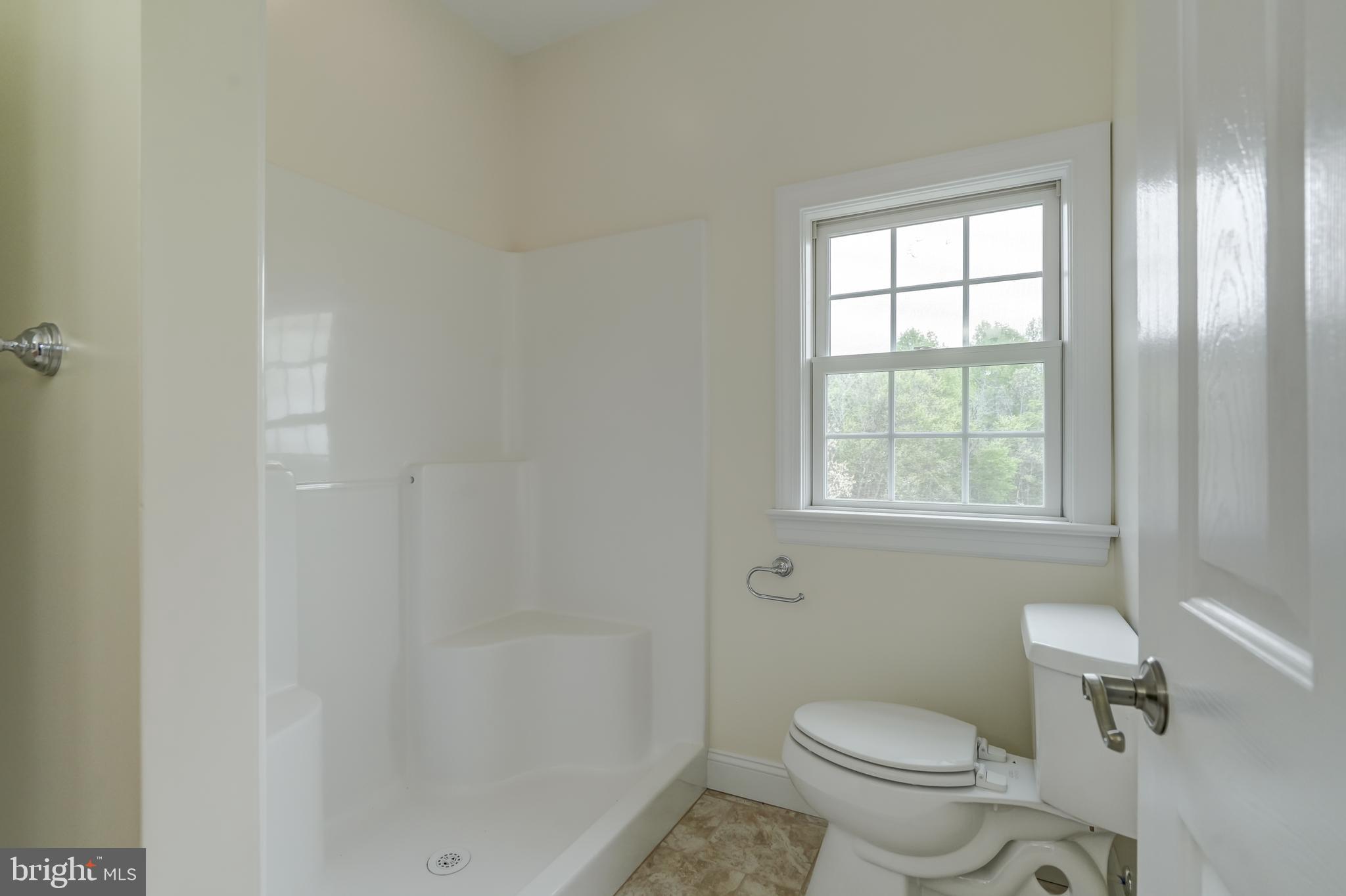 2066 Byrd's Mill Road Newtown, VA 23126 - Photo 36 of 61 a white toilet sitting next to a window