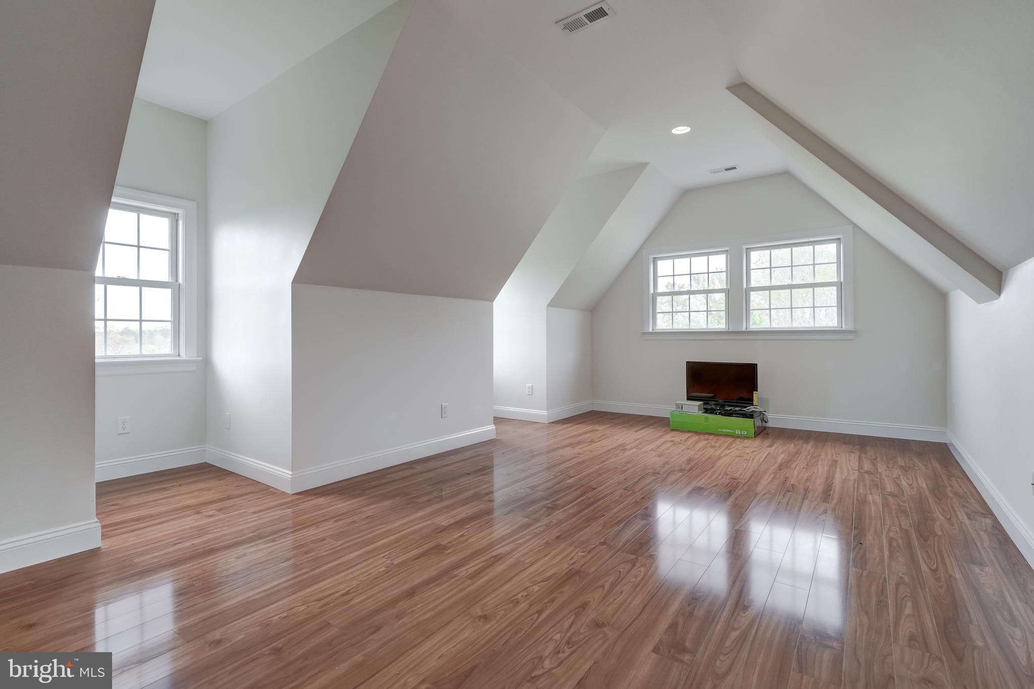 2066 Byrd's Mill Road Newtown, VA 23126 - Photo 37 of 61 an empty room with wooden floor and fireplace