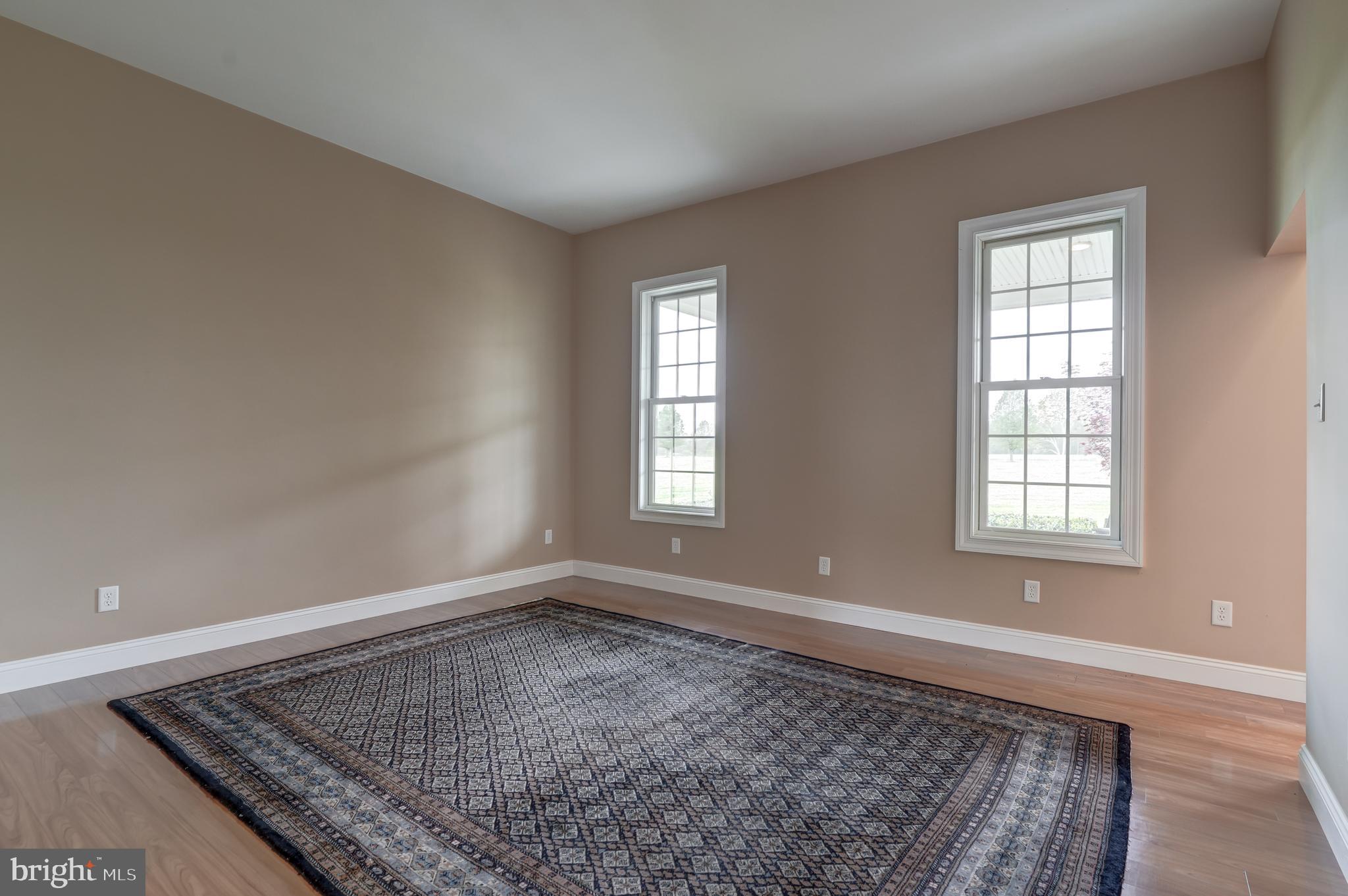 2066 Byrd's Mill Road Newtown, VA 23126 - Photo 39 of 61 an empty room with wooden floor and windows