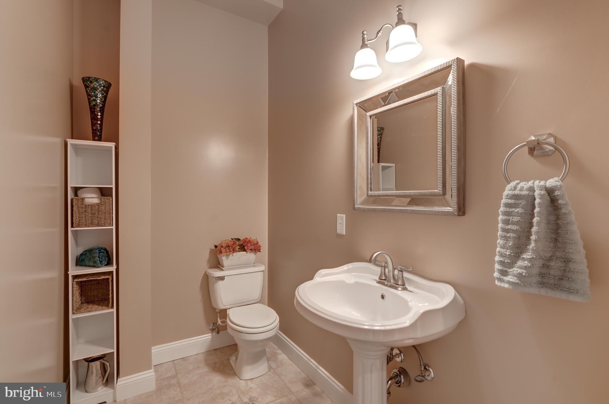 2066 Byrd's Mill Road Newtown, VA 23126 - Photo 41 of 61 a bathroom with a toilet a sink and mirror