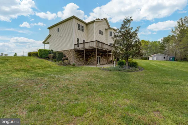 a view of a big yard with a house in the background