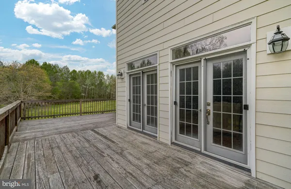 a view of a house with a big yard and potted plants