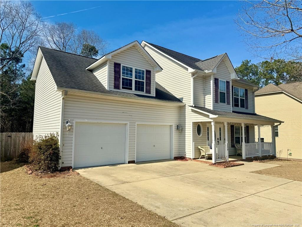 234 Pender Road Spring Lake, NC 28390 - Photo 3 of 39 a front view of a house with a yard and garage