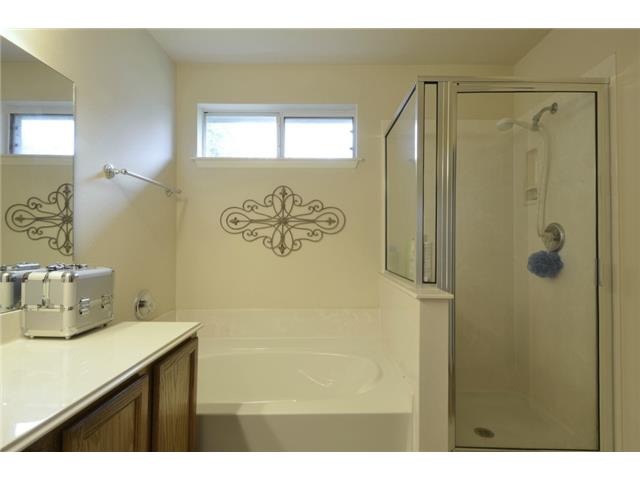 11612 Timber Heights Drive Austin, TX 78754 - Photo 16 of 28 Indulge in a primary bathroom featuring a spacious soaking tub and a separate walk-in shower.