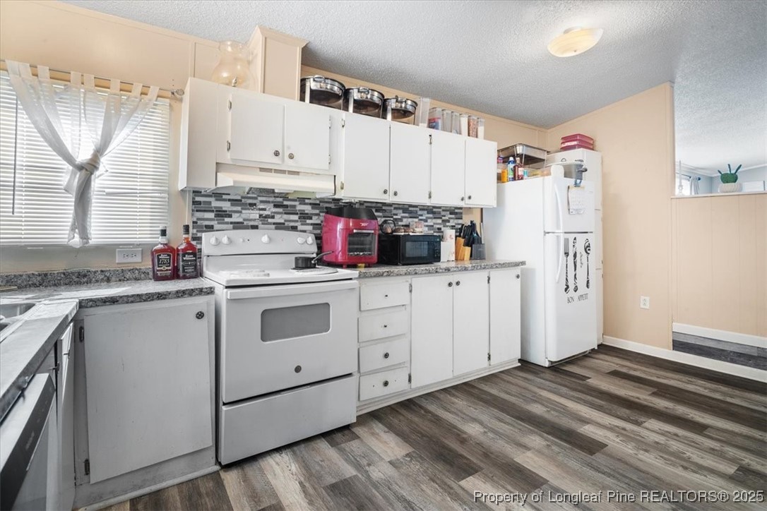 538 Participle Court Hope Mills, NC 28348 - Photo 11 of 32 a kitchen with white cabinets and white appliances