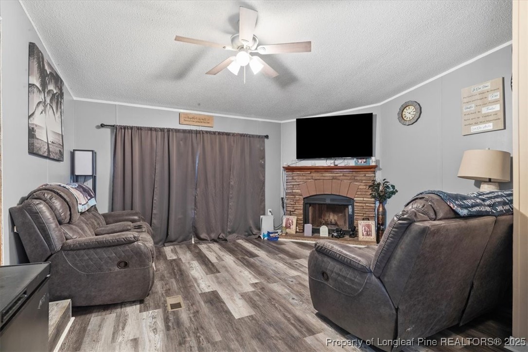 538 Participle Court Hope Mills, NC 28348 - Photo 14 of 32 a living room with furniture a fireplace and a flat screen tv