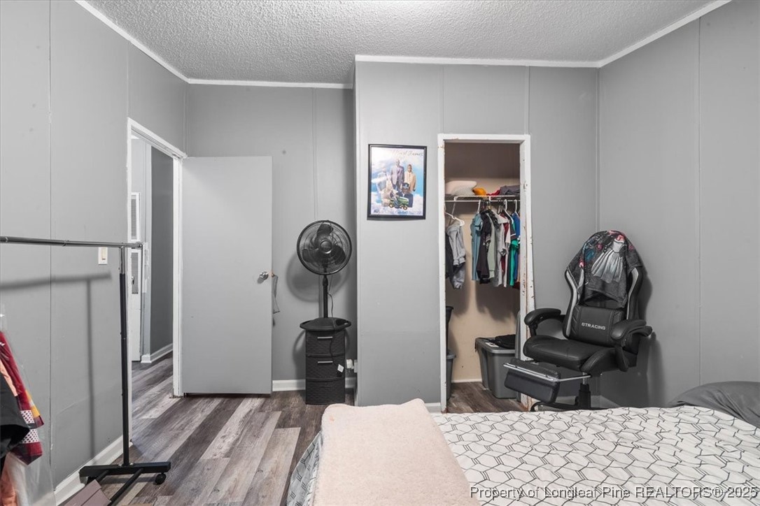 538 Participle Court Hope Mills, NC 28348 - Photo 20 of 32 a bedroom with a bed and wooden floor