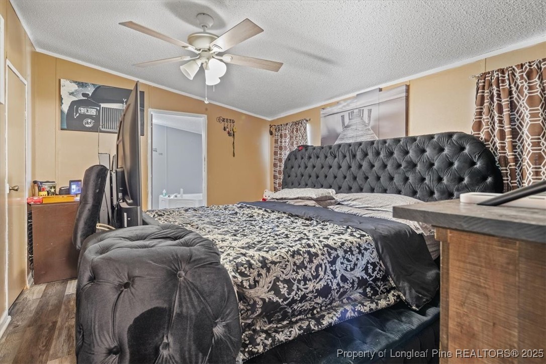 538 Participle Court Hope Mills, NC 28348 - Photo 25 of 32 a bedroom with a bed and a chandelier