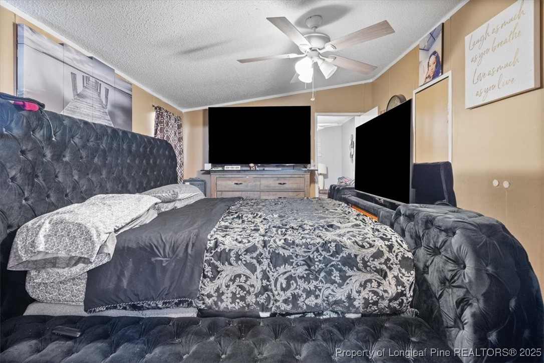 538 Participle Court Hope Mills, NC 28348 - Photo 26 of 32 a bedroom with a bed and a flat screen tv