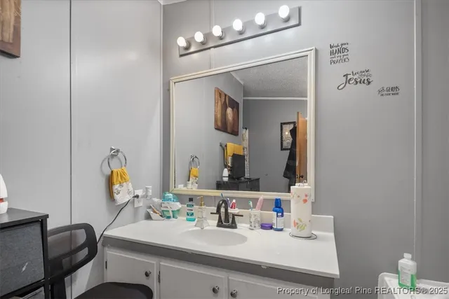a bathroom with a sink vanity and mirror