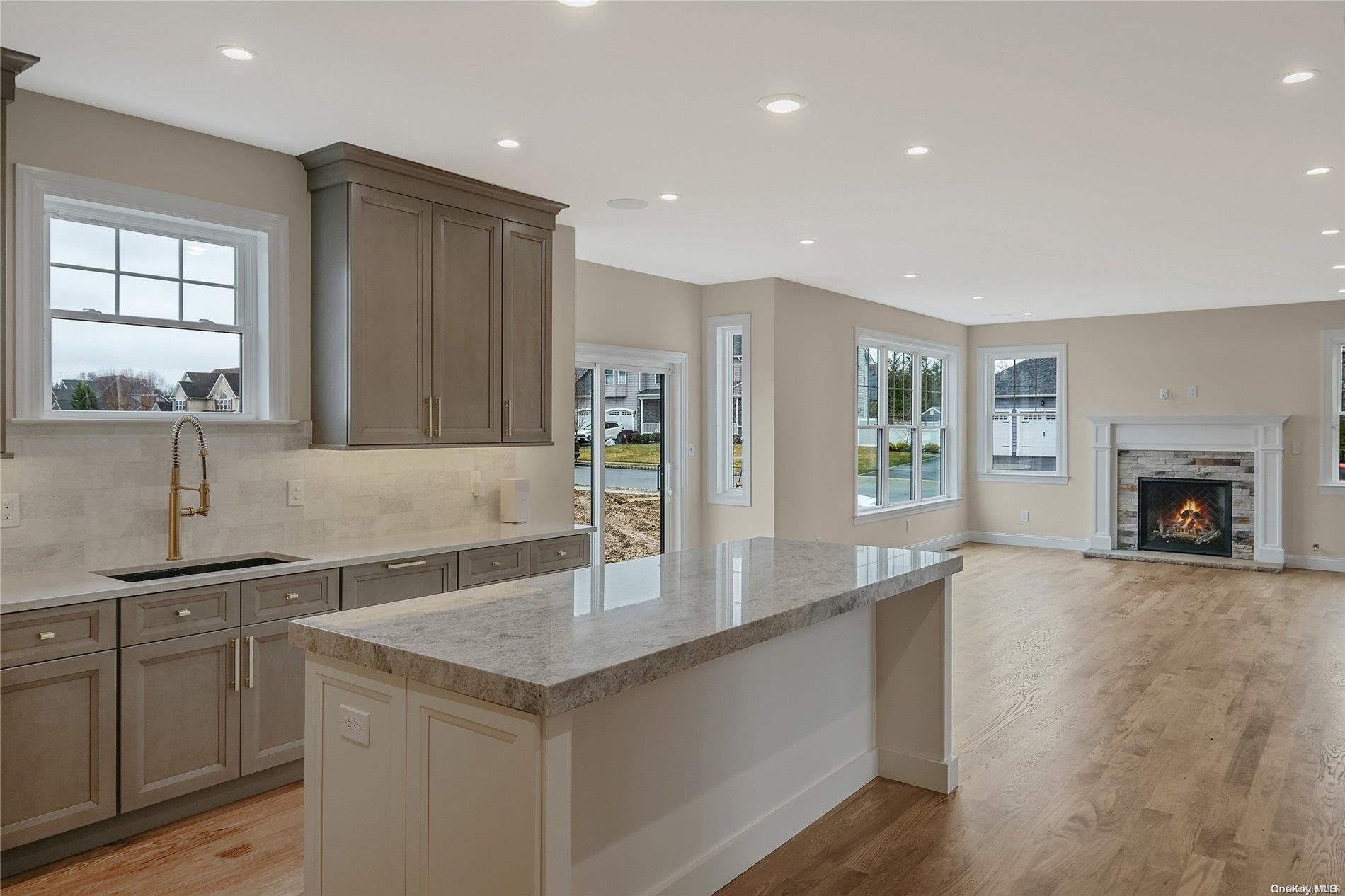 Lot 9 Sycamore Estates Nesconset, NY 11767 - Photo 15 of 35 a large kitchen with kitchen island a sink stainless steel appliances and cabinets