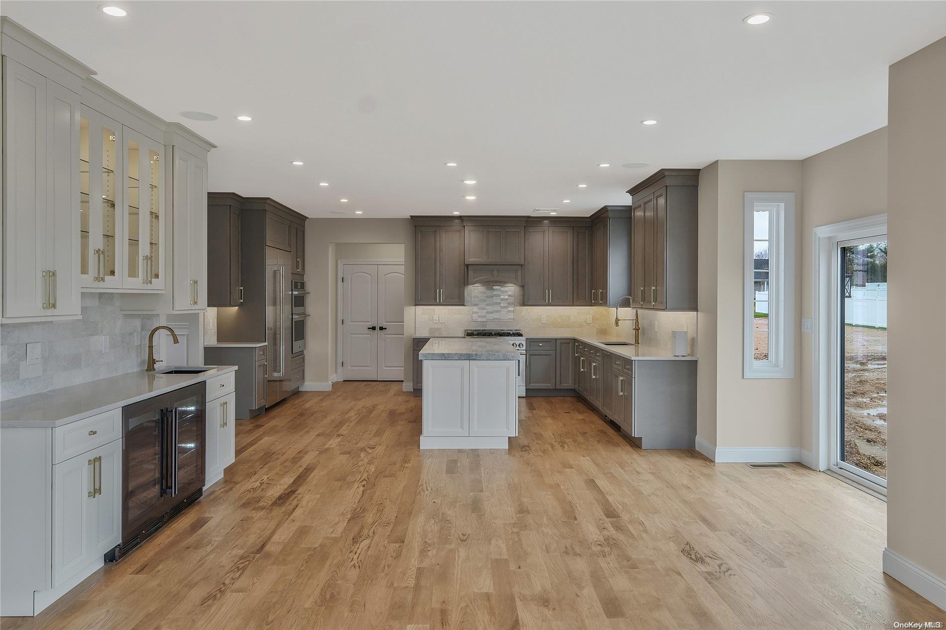 Lot 9 Sycamore Estates Nesconset, NY 11767 - Photo 16 of 35 a large kitchen with stainless steel appliances lots of counter top space and cabinets