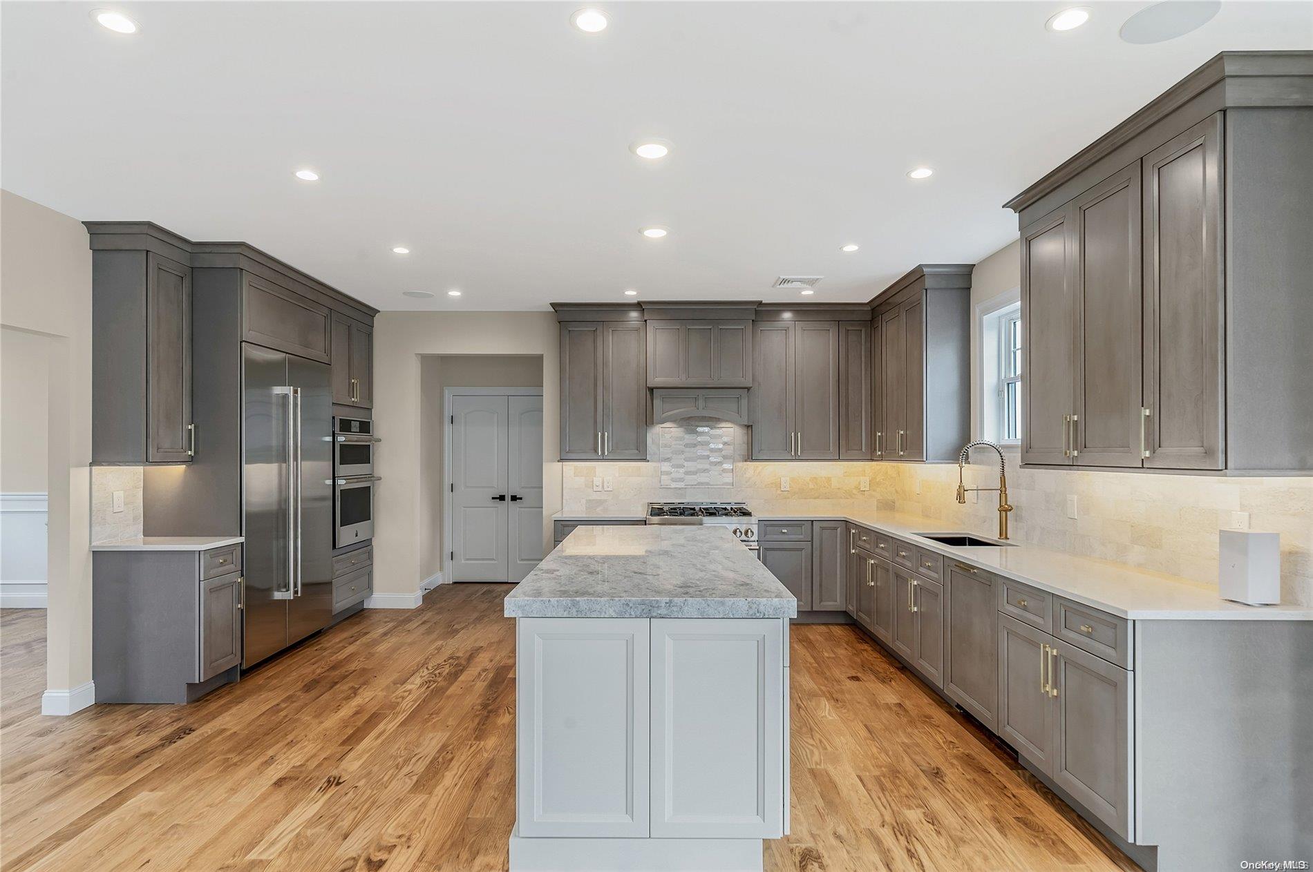 Lot 9 Sycamore Estates Nesconset, NY 11767 - Photo 18 of 35 a kitchen with stainless steel appliances granite countertop a sink refrigerator and cabinets