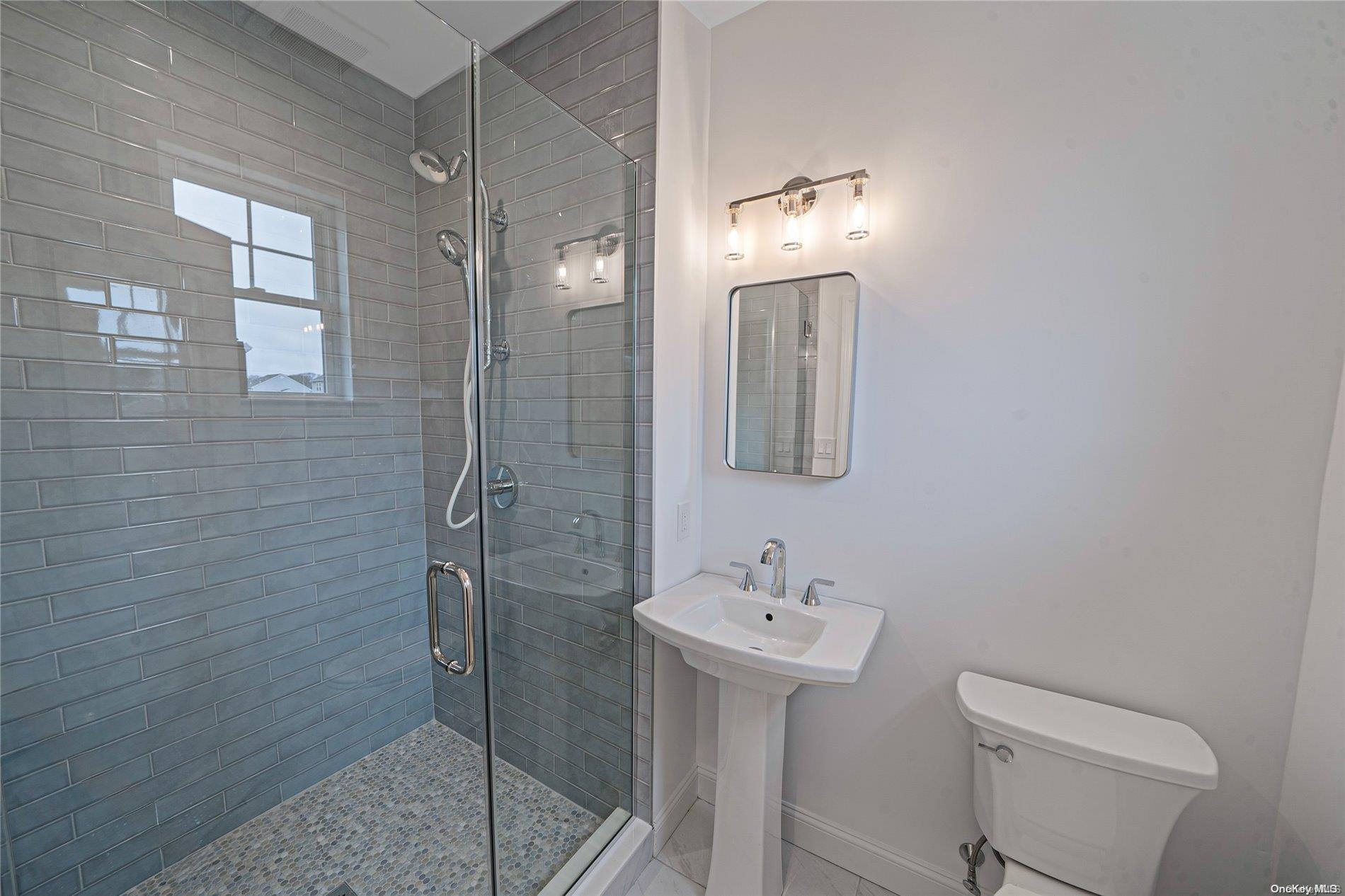 Lot 9 Sycamore Estates Nesconset, NY 11767 - Photo 29 of 35 a bathroom with a sink toilet and shower