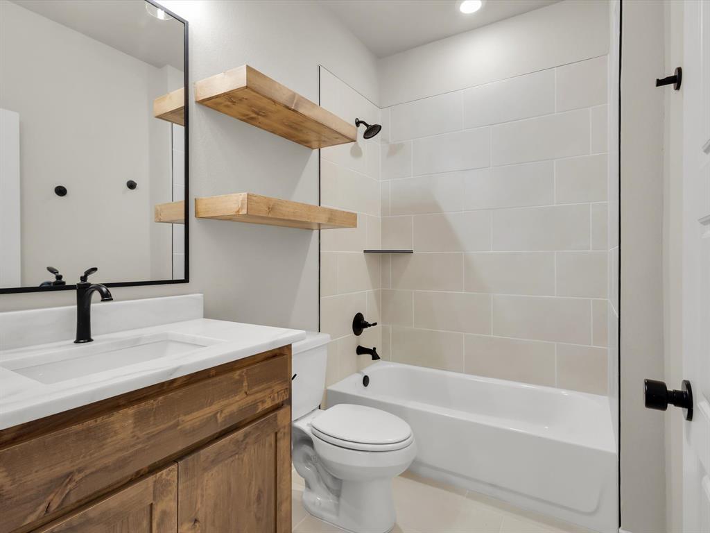 612 Jameson Springtown, TX 76082 - Photo 11 of 13 a bathroom with a sink a toilet and shower
