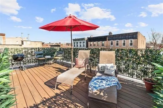 a view of a roof deck with furniture