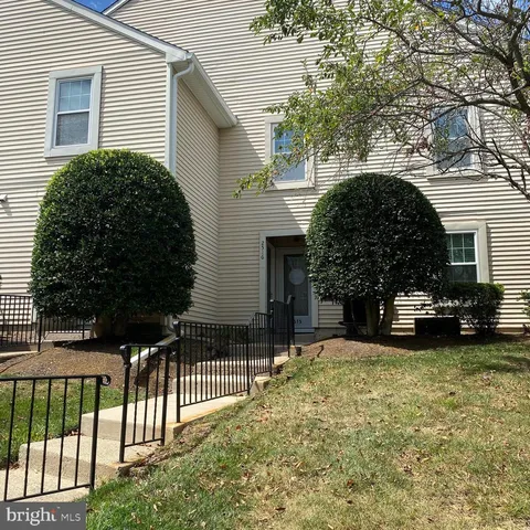 a view of a house with a yard and plants