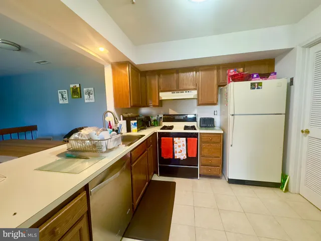 a kitchen with a refrigerator a stove a sink and a refrigerator