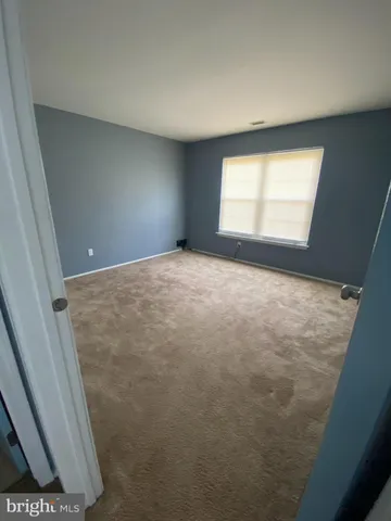 a view of an empty room and a window