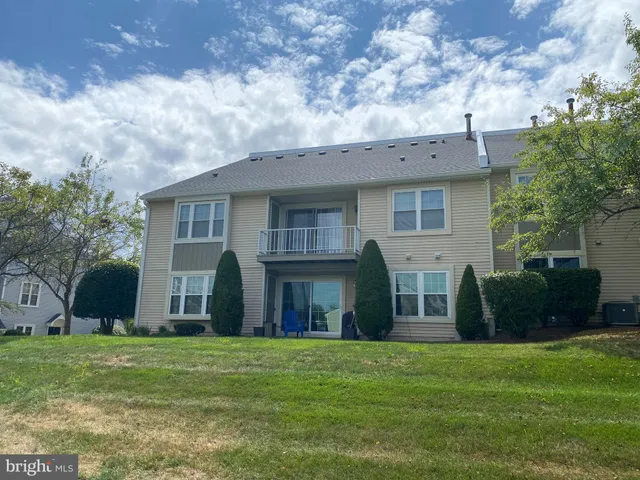 a view of a house with backyard and porch