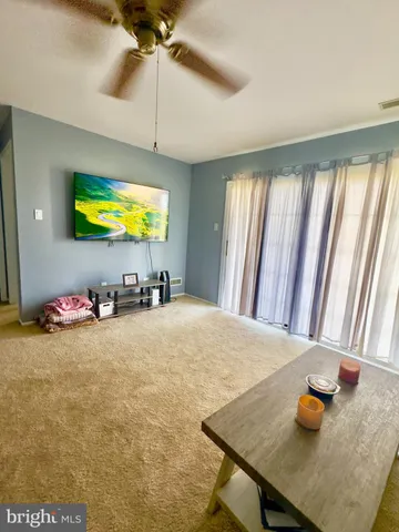 a view of a room with furniture and window