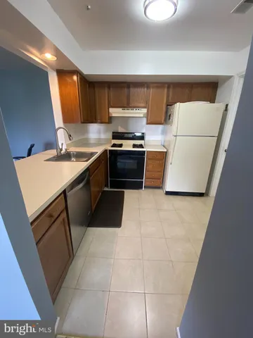 a large kitchen with a stove and a refrigerator