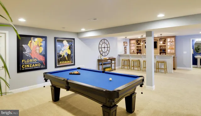 a room with furniture pool table and windows