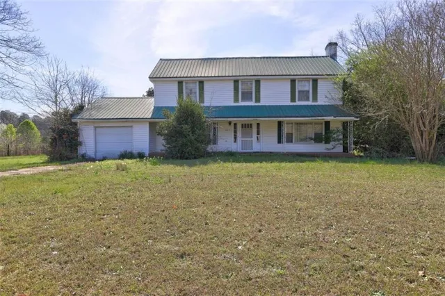 a front view of house with yard and green space