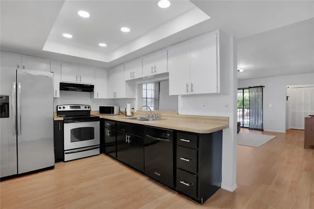a kitchen with a sink stove and refrigerator