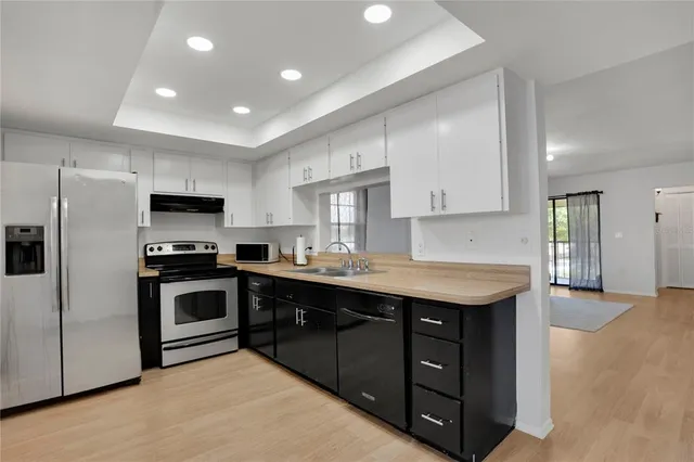 a bathroom with a sink a toilet and shower curtain
