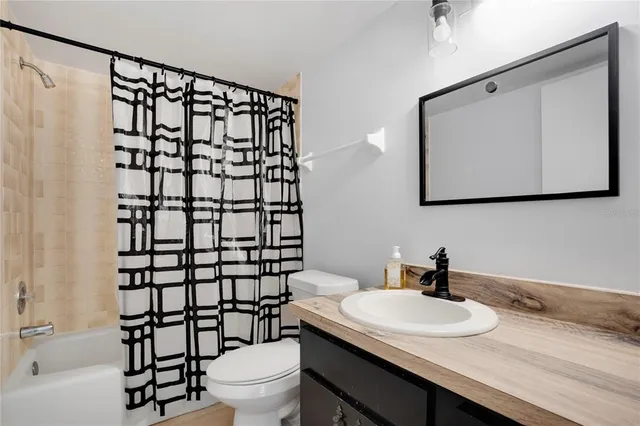 a living room with furniture and a ceiling fan