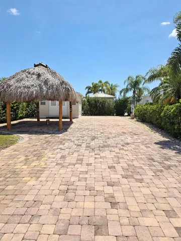a big house with a big yard and large trees