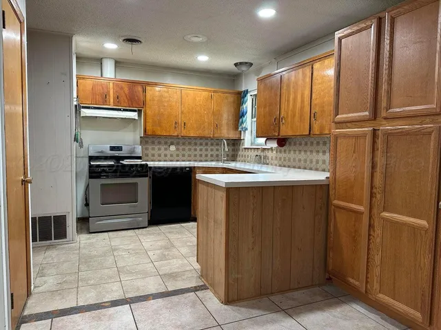 a view of a kitchen with a sink and a refrigerator