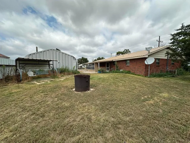 a view of a house with backyard porch and sitting area