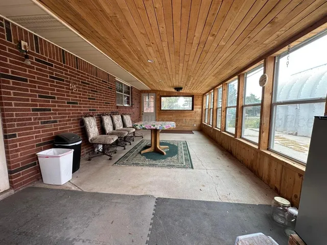 a living room with furniture a rug floor to ceiling windows and a rug