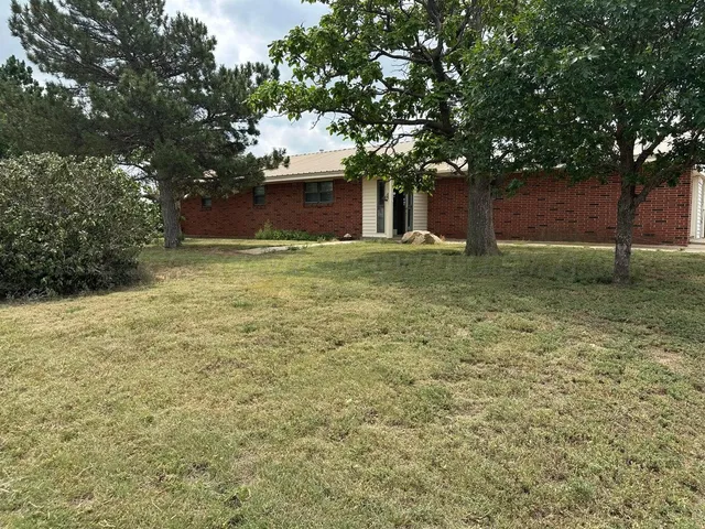 a big yard with large trees