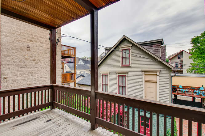 1429 West Roscoe Street Chicago, IL 60657 - Photo 11 of 65 a view of a wooden house and a small yard