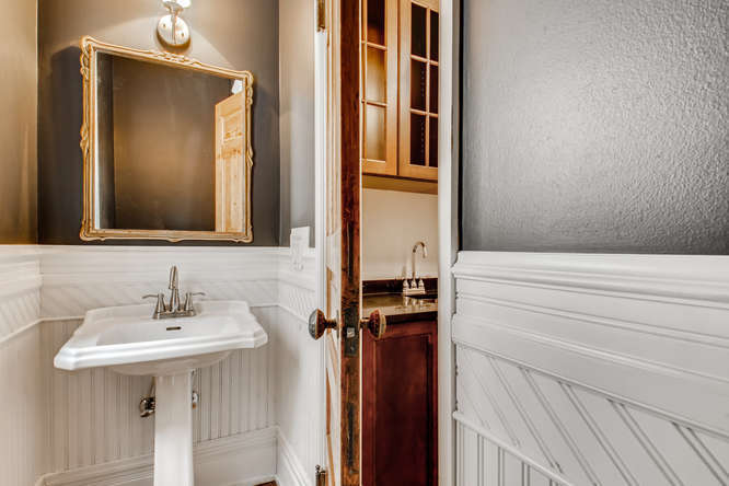 1429 West Roscoe Street Chicago, IL 60657 - Photo 12 of 65 a bathroom with a sink and a mirror