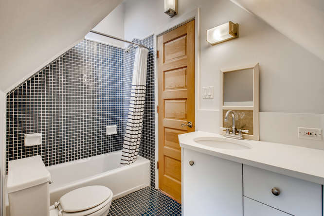 1429 West Roscoe Street Chicago, IL 60657 - Photo 22 of 65 a bathroom with a sink toilet and shower