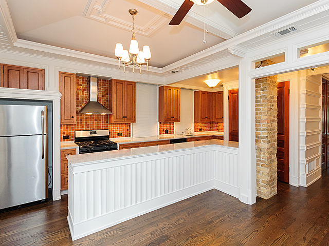 1429 West Roscoe Street Chicago, IL 60657 - Photo 26 of 65 a kitchen with stainless steel appliances granite countertop a refrigerator a sink dishwasher a stove and a dining table with wooden floor