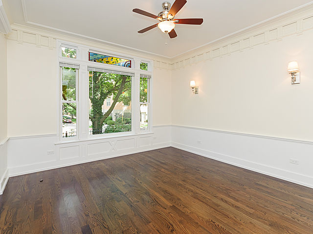 1429 West Roscoe Street Chicago, IL 60657 - Photo 34 of 65 an empty room with wooden floor fan and windows