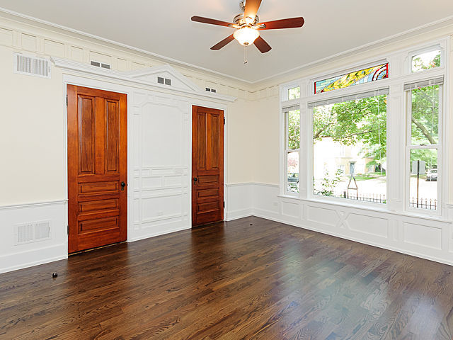 1429 West Roscoe Street Chicago, IL 60657 - Photo 35 of 65 a view of an empty room with wooden floor and a window
