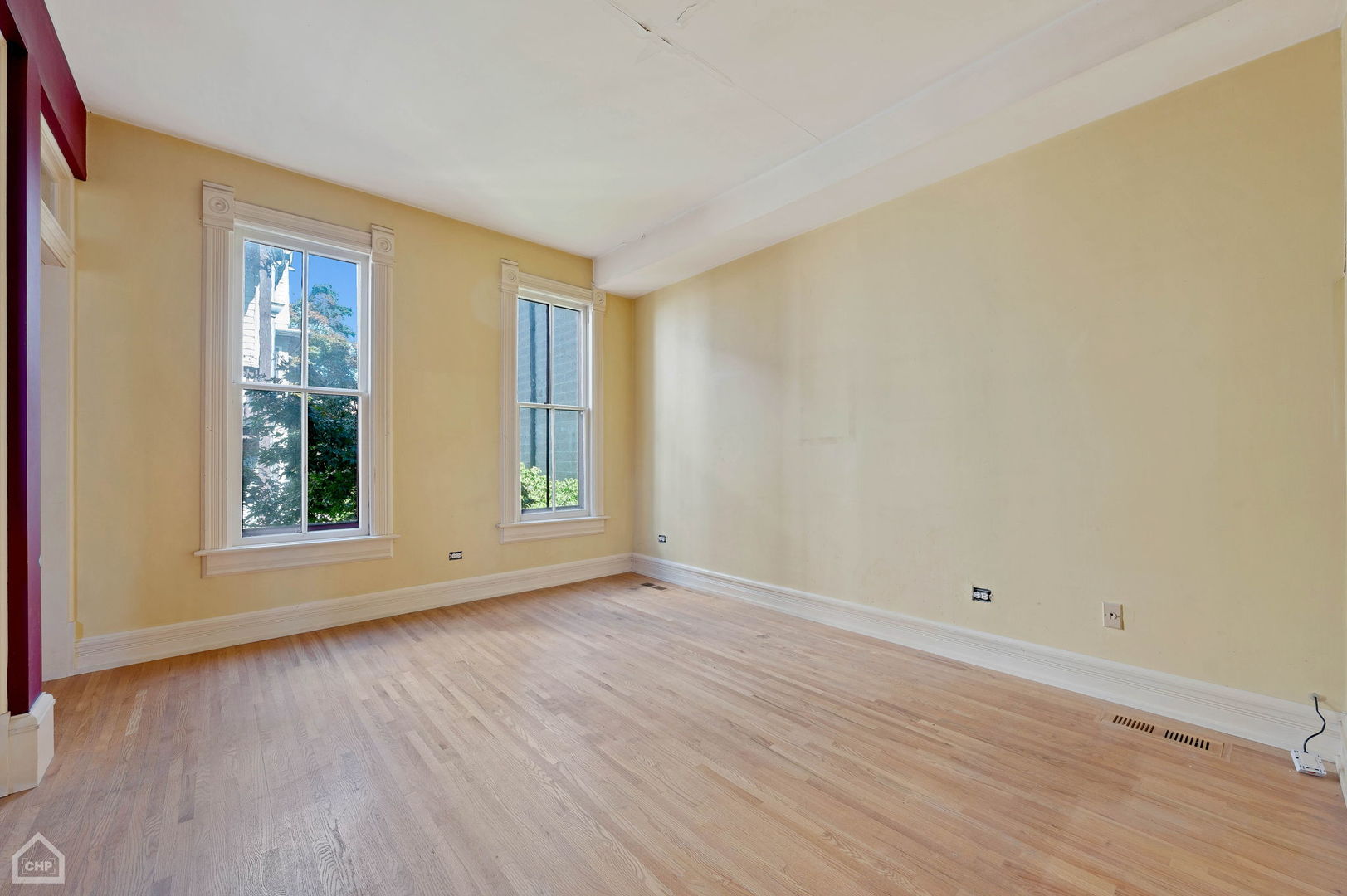 1429 West Roscoe Street Chicago, IL 60657 - Photo 43 of 65 a view of an empty room with wooden floor and a window