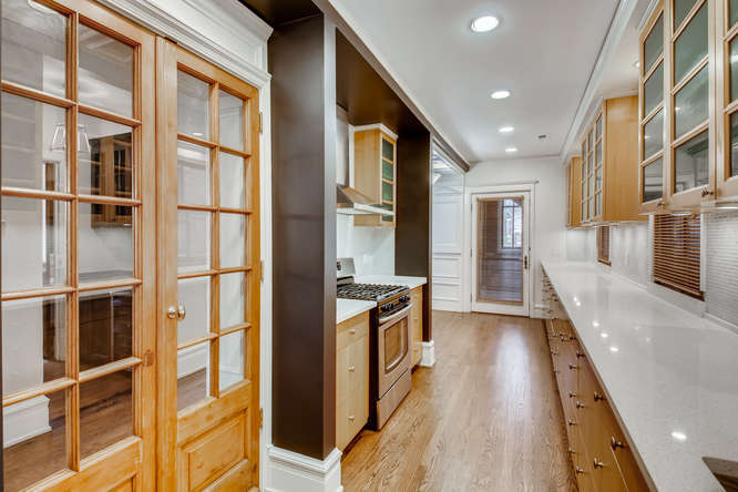 1429 West Roscoe Street Chicago, IL 60657 - Photo 9 of 65 a view of a kitchen with a sink and cabinets