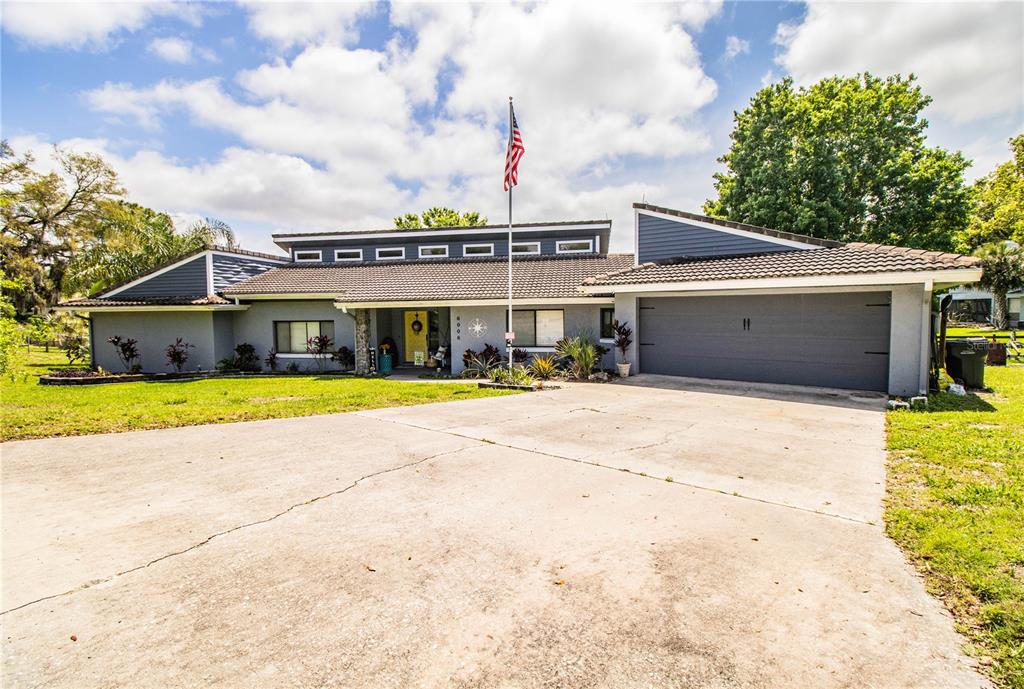 a view of house with swimming pool outdoor seating