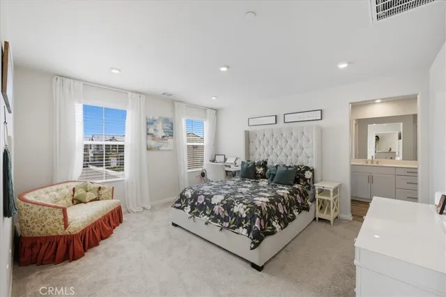 a spacious bathroom with a double vanity sink mirror and bathtub
