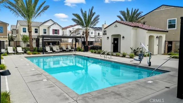 a view of house with swimming pool outdoor seating