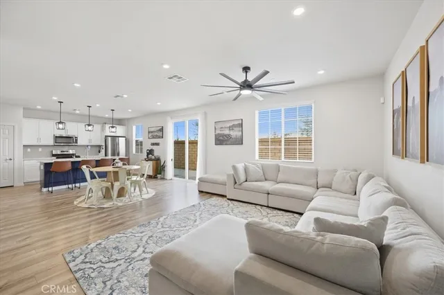 a living room with furniture and kitchen view